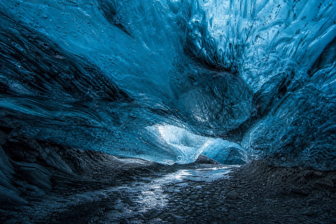 The glowing blue interior of a natural crystal ice cave under Vatnajökull glacier in winter