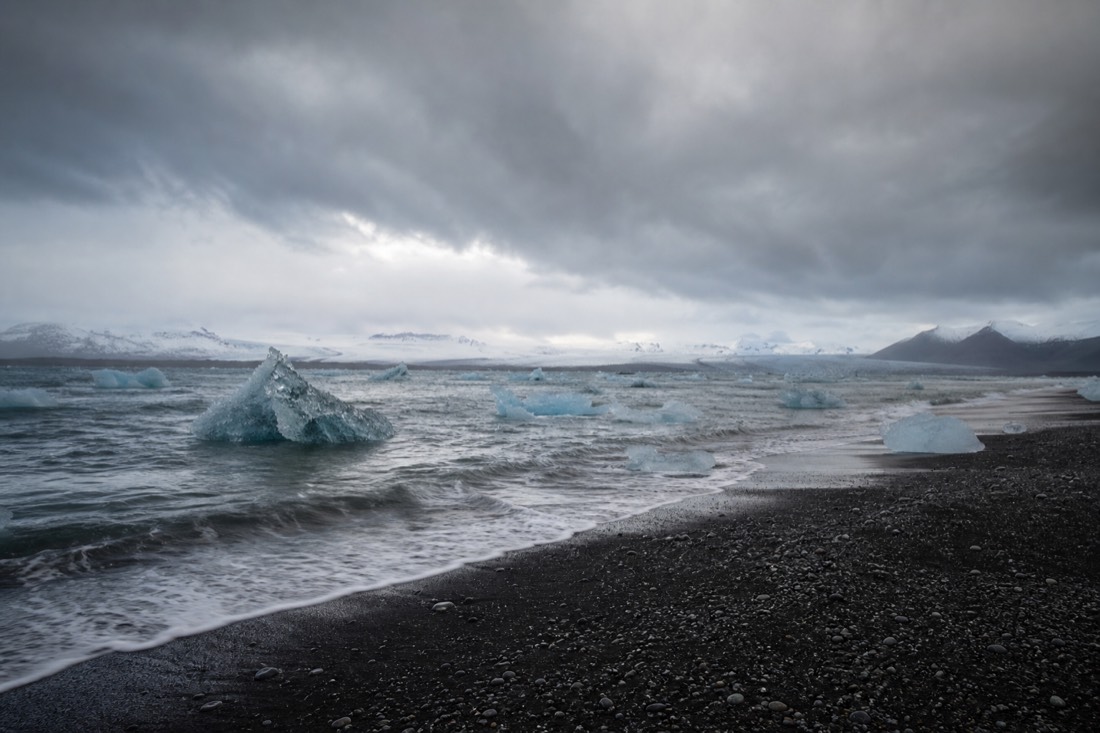 Jökulsárlón glacier lagoon with drifting icebergs on one side of Route 1 and the black sand of Diamond Beach on the other in south-east Iceland