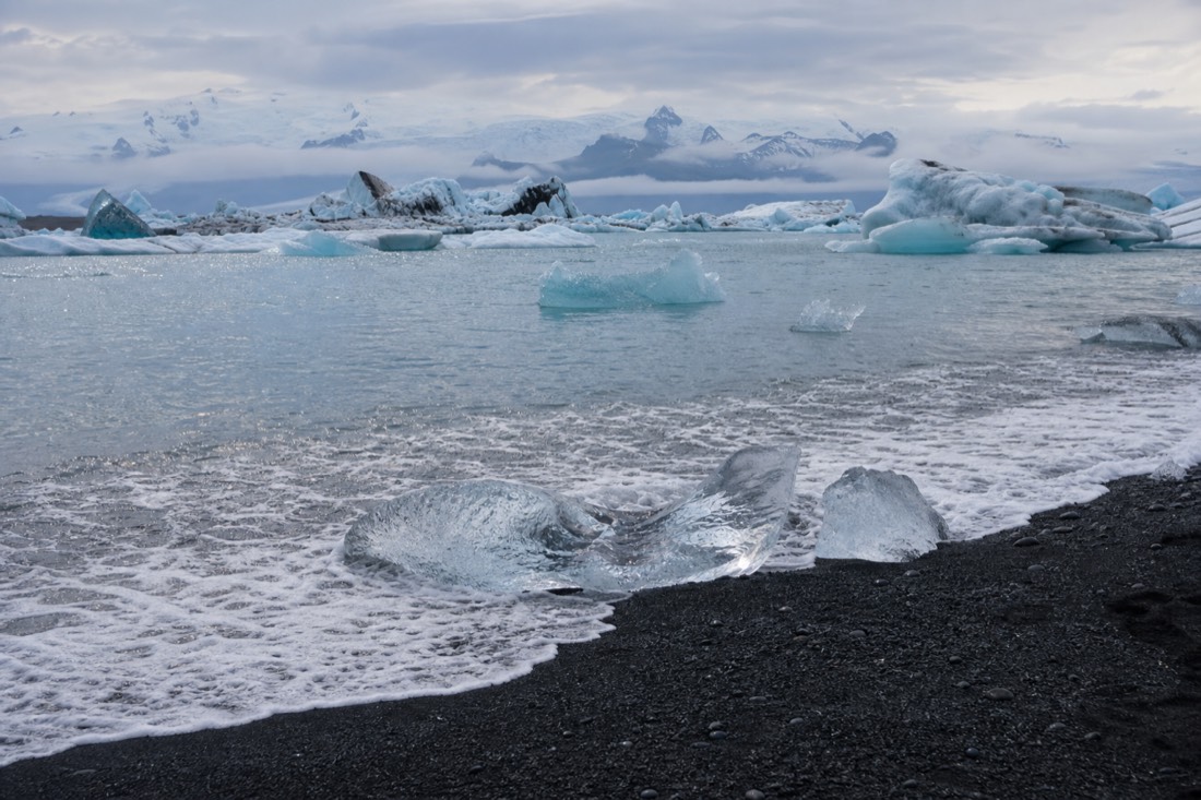 Jökulsárlón glacier lagoon with drifting icebergs beside the black sand of Diamond Beach in south-east Iceland