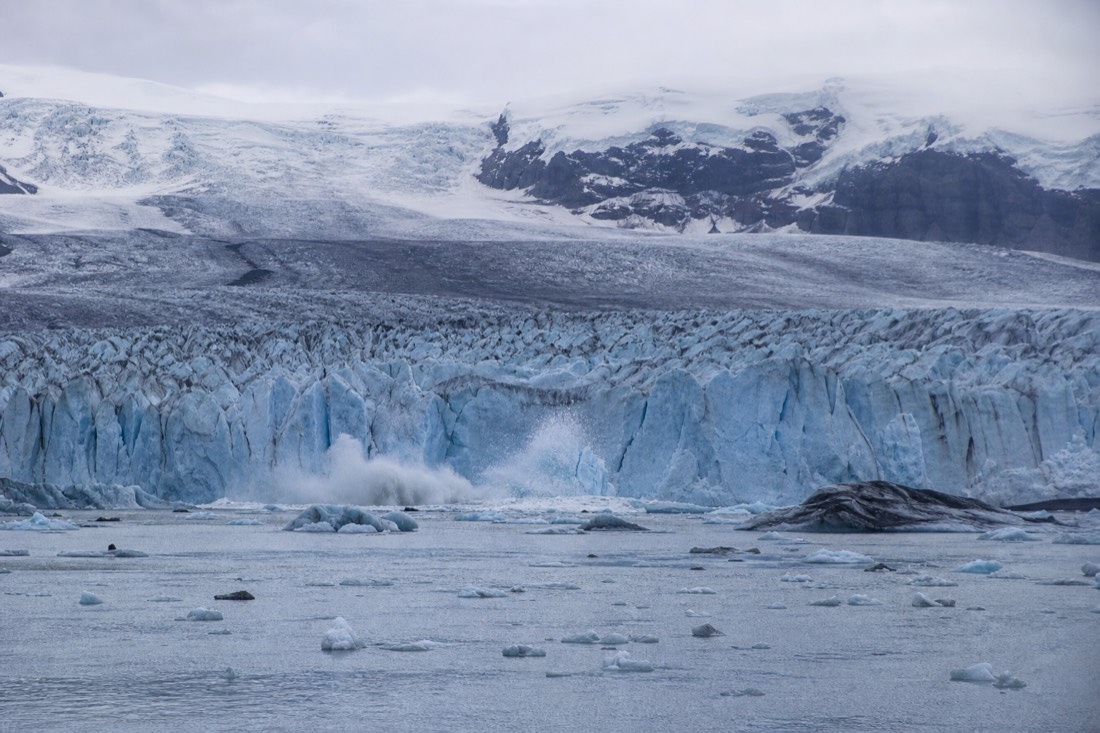 The Breiðamerkurjökull glacier tongue meeting Jökulsárlón lagoon with icebergs breaking away at the ice front